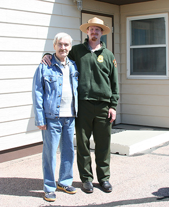 Stanislav Petrov standing with a National Park Service ranger in front of the Delta-01 Minuteman launch control facility in South Dakota, May 2007